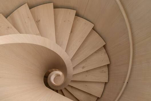 Transforming a Concrete Shell into a Wooden Interior Shaped by the Sea